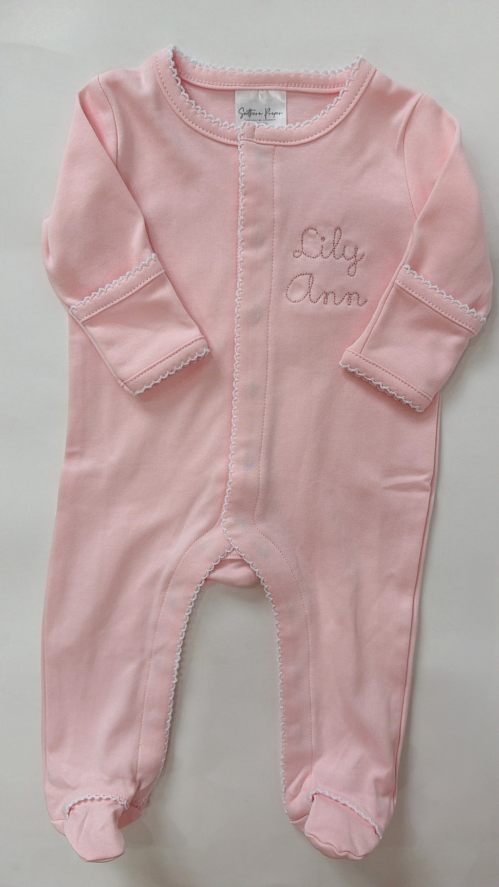Pink onesie with white picot trim