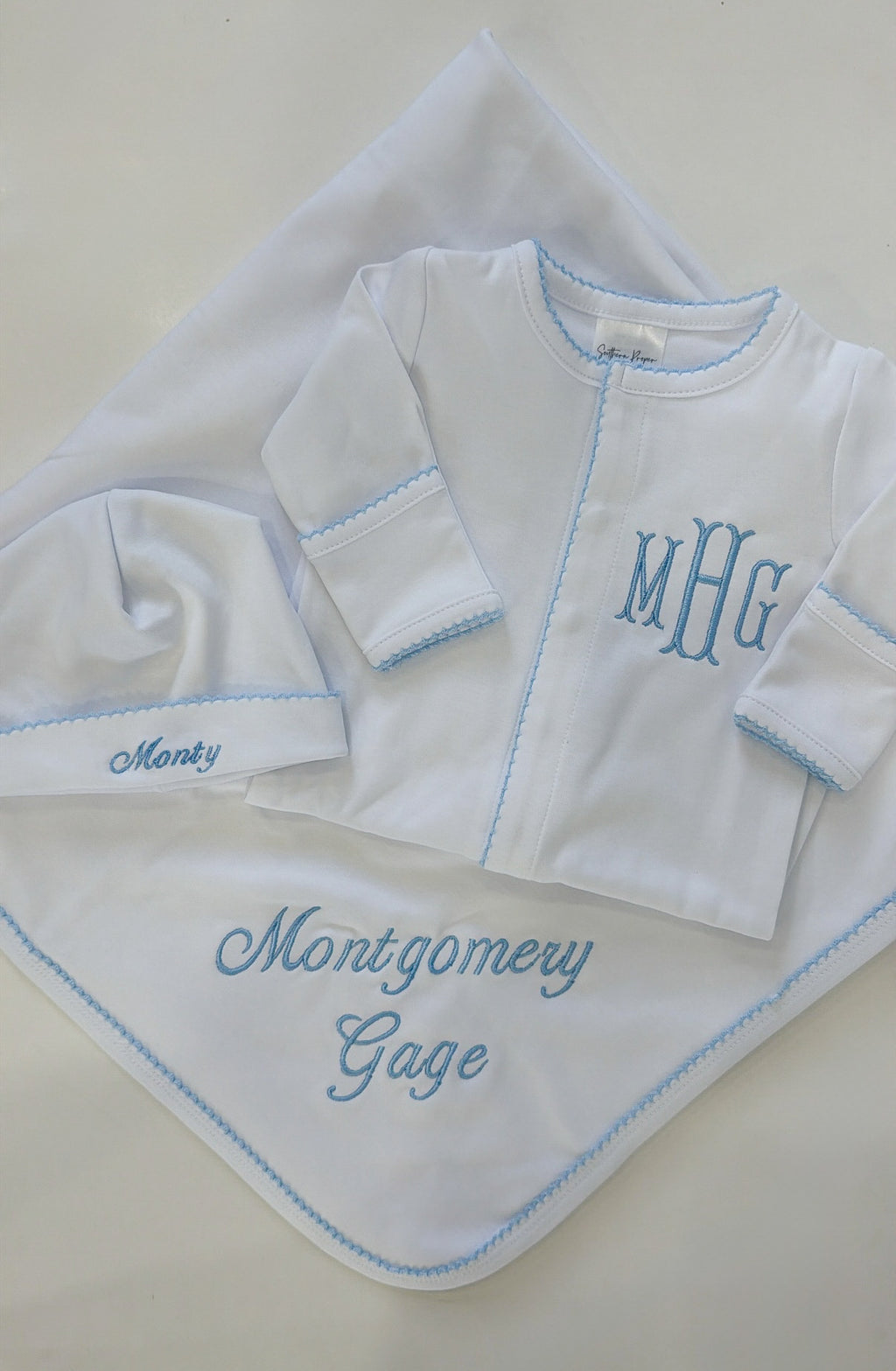 White oneise with blue picot trim