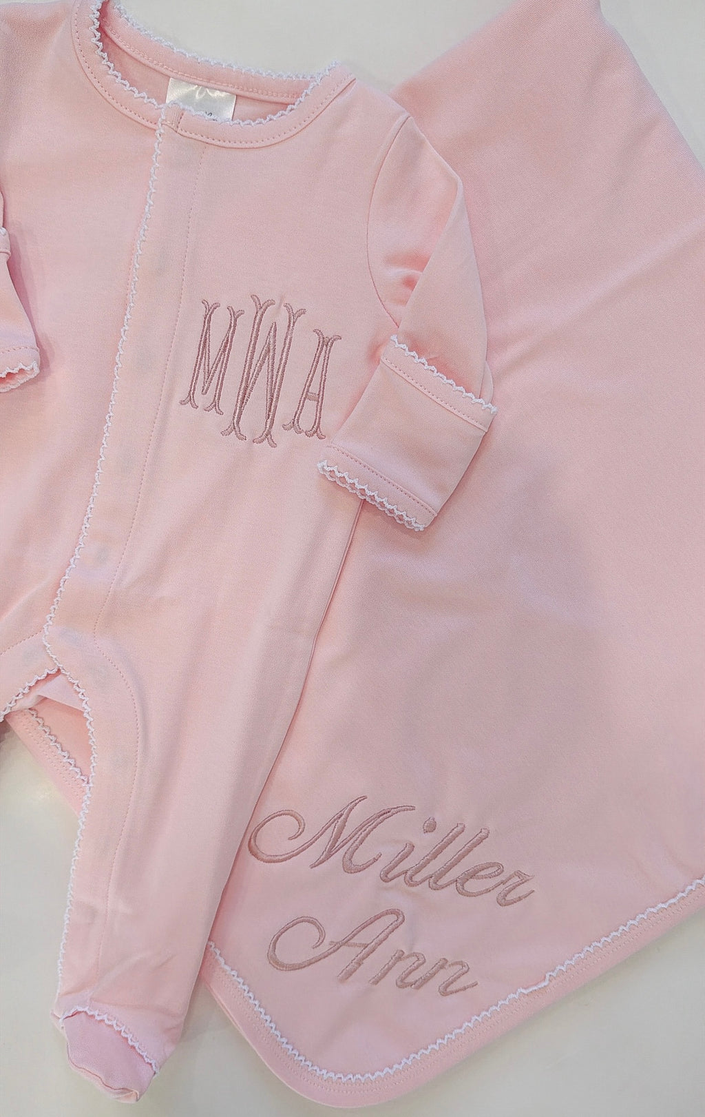 Pink onesie with white picot trim